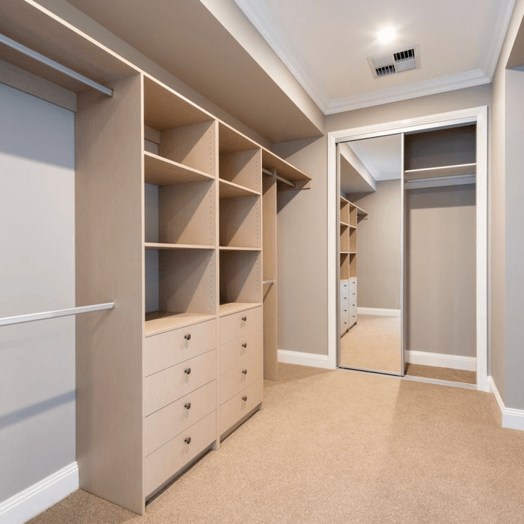 Walk-in closet with built-in shelving and drawers