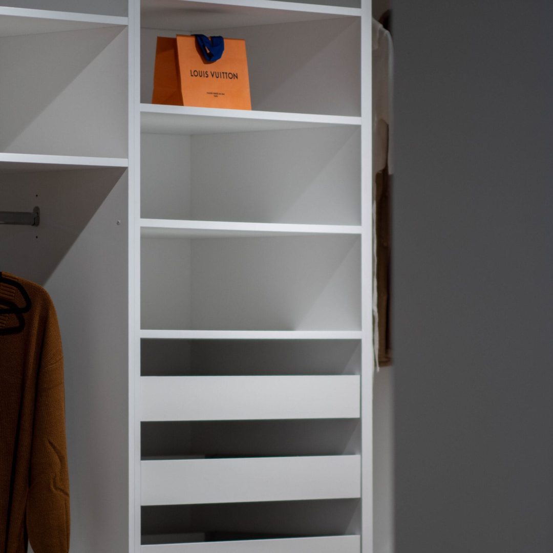White closet shelving and built-in drawers
